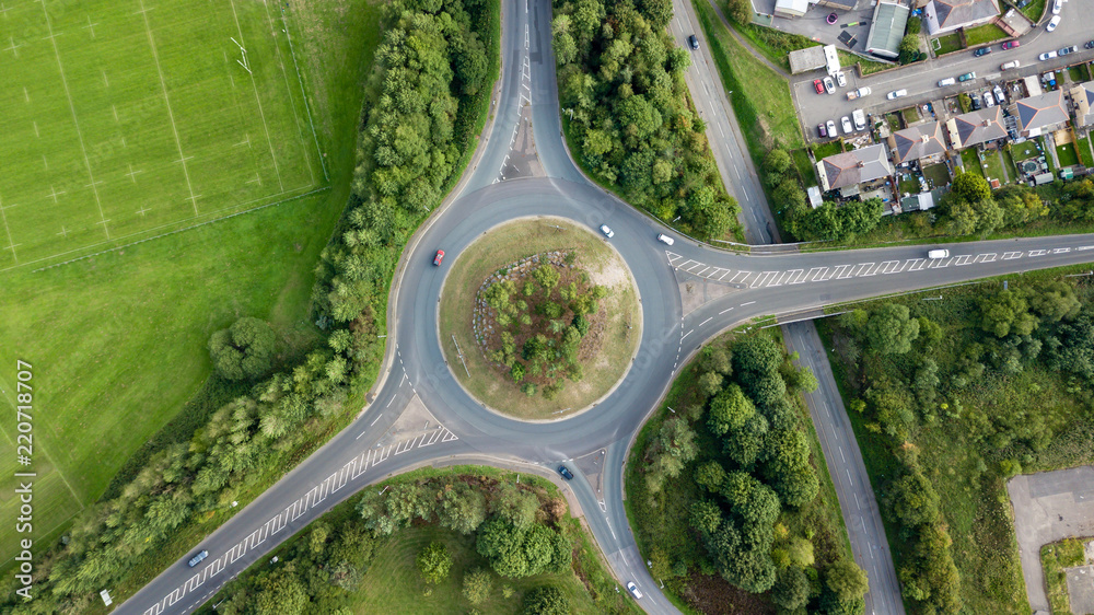 Poster top down aerial view of a traffic roundabout on a main road in an urban area of the uk - Posters