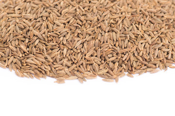 Pile of cumin seeds isolated on white background