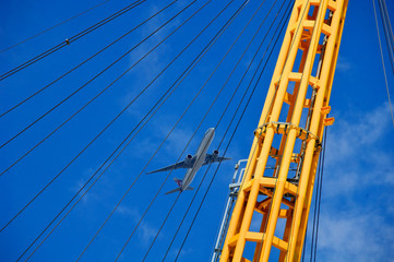 Airplane taking off from London City Airport and Cable Support lines , O2 Arena, London 