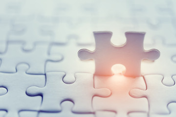 Jigsaw with one piece missing revealing