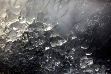 Abstract Macro Ice Texture image, photograph of smooth transparent ice surface glistening in the...
