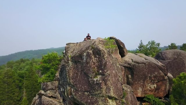 Aerial view people on the top of rock in Krasnoyarsk national park drone footage