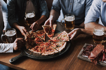 Close up of People Hands Taking Slices of Pizza