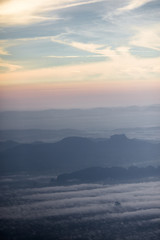 Background, high angle from the passenger plane. You can see the scenery by the distance (mountains, rivers, sky, fog, houses), the photos may be blurred during the flight.
