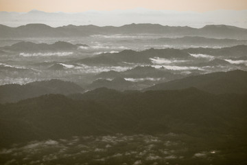 Background, high angle from the passenger plane. You can see the scenery by the distance (mountains, rivers, sky, fog, houses), the photos may be blurred during the flight.