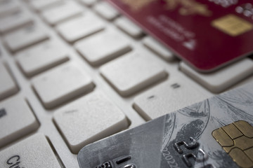 Close up credit card lie on white computer keyboard. Concept of internet purchase. Bank Credit Card on a Computer Keyboard
