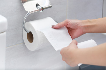 Close-up of Hand Using Toilet Paper. - 220729534