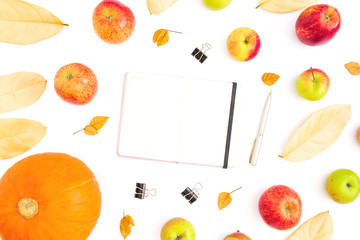 Thanksgiving day. Autumn composition of fall leaves, apple fruit and pumpkin with notebook, pen and clips on white background. Flat lay, top view