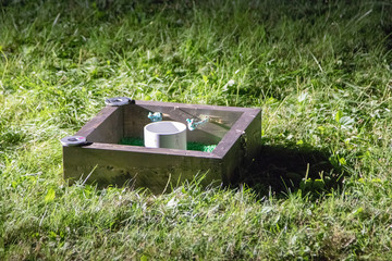 Washer toss box at night with washers on rim.