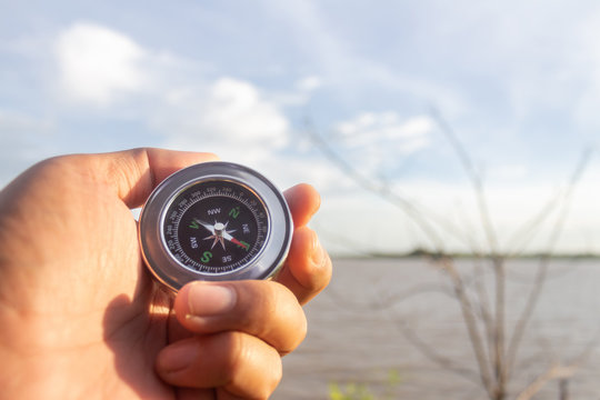 A compass in the palm of my hand that is looking for a destination on the river
