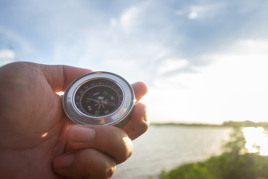 A compass in the palm of my hand that is looking for a destination on the river