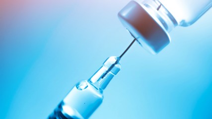 Vaccine vial dose flu shot drug needle syringe,medical concept vaccination hypodermic injection treatment disease care hospital prevention immunization illness disease  baby child.blue background 