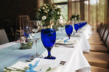 Decorated table for wedding celebration. Bright restaurand with a lot of windows