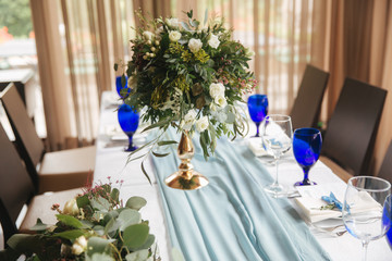 Decorated table for wedding celebration. Bright restaurand with a lot of windows