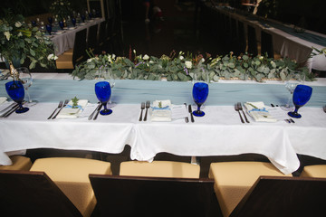 Decorated table for wedding celebration. Bright restaurand with a lot of windows