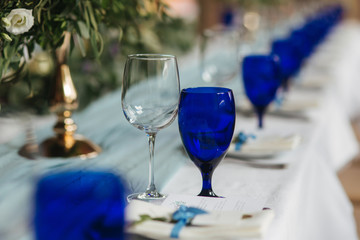 Table appointsment in restaurant. Wedding decoration in blue style