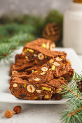 Fototapeta na wymiar Italian Christmas dessert panforte with nuts, chocolate and candied fruits. Christmas background