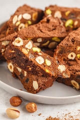 Italian dessert panforte with nuts, chocolate and candied fruits. White background, Italian food concept.