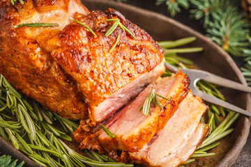 Baked Christmas pork (ham) with rosemary. Christmas decoration, festive background concept.