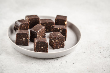 Chocolate nuts halva with honey. Healthy vegan food concept.