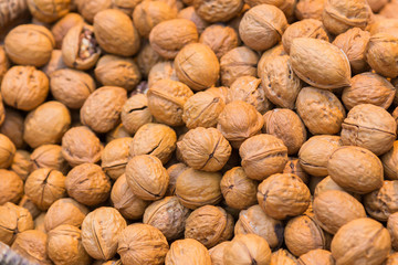 Pile of whole salted walnut with sheel