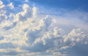 Naklejka na ściany i meble Blue sky background with white fluffy clouds.