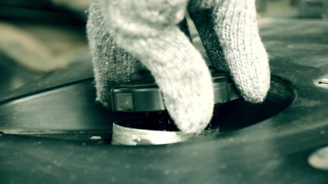 hand in knitted glove close and open engine oil cap