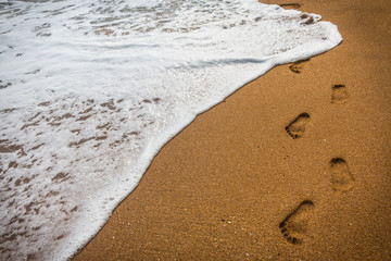 Footprints in the sand with sea nature background
