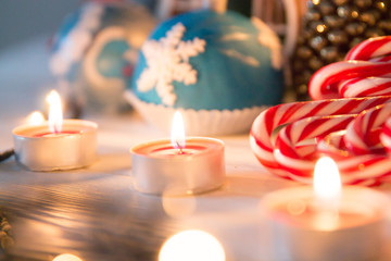 Candy Canes with Christmas decoration and lights on a wooden board