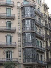 Fototapeta na wymiar Fragment of the facade of a beautiful house with glazed balconies