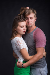 Lovers kissing each other on black background