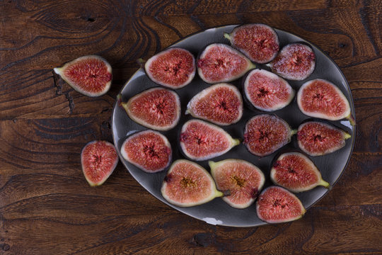 juicy fresh cut figs on a plate on a rustic table