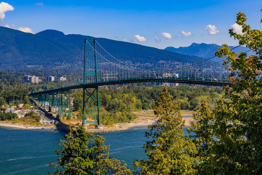 Lions Gate or First Narrows Bridge in Stanley Park Vancouver Canada with North Vancouver and mountains in the background