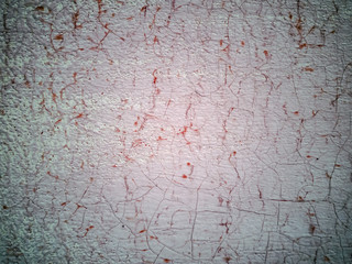 Close-up  of cracked paint on  metal wall