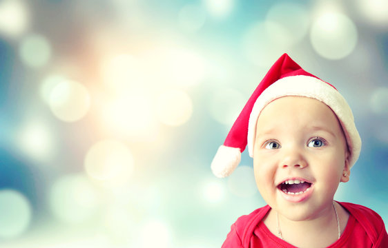 Toddler child in santa hat empty space background.
