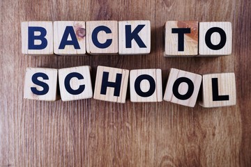 Fototapeta premium back to school text alphabet letters on wooden background