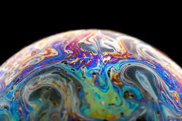 Iridescent soap bubble representing model of planet