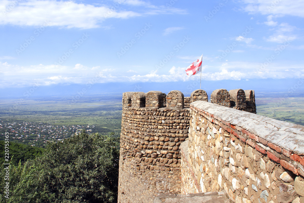 Poster flag of georgia on medieval fortress wall, sighnaghi, georgia