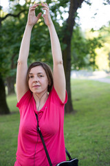 Woman in headphones listens to music and dances on the street