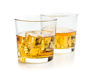 Glass of alcoholic drink with ice cubes.