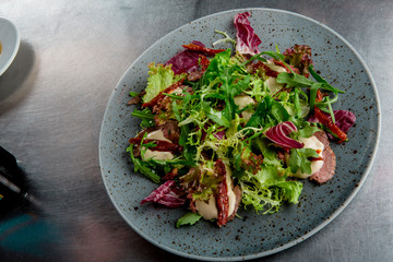 salad with cold beef in grey plate