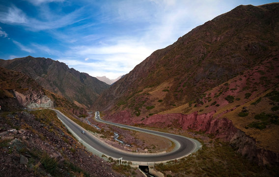 Serpentine road in Too-Ashuu pass and Kara Balta river and valley in Chuy Region of Kyrgyzstan