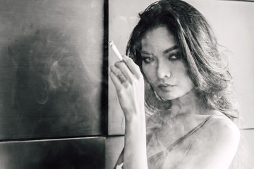 Fashion portrait of  beautiful woman sexy slim body smoking cigarette