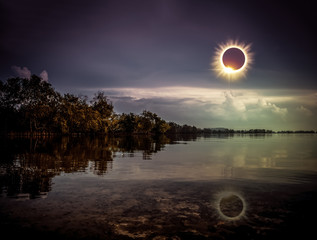 Scientific natural phenomenon. Total solar eclipse with diamond ring effect glowing on sky. - obrazy, fototapety, plakaty