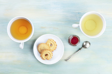 An overhead photo of tea, on a teal background with copy space