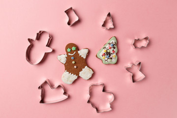 Christmas cookies various shape cutter on pink background. Top view. Flat lay. Trendy colorful photo. Minimal style with colorful paper backdrop. Christmas concept.