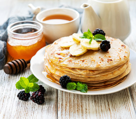 Delicious pancakes with blackberries and bananas