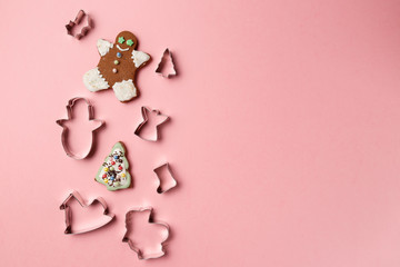 Christmas cookies various shape cutter on pink background with copy space. Top view. Flat lay. Trendy colorful photo. Minimal style with colorful paper backdrop. Christmas concept.