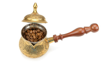 Coffeepot and coffee beans isolated on white background.