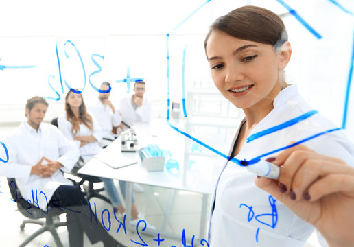 view through the transparent Board. female biochemist analyzing information.